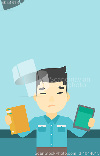 Image of Man choosing between book and tablet computer.