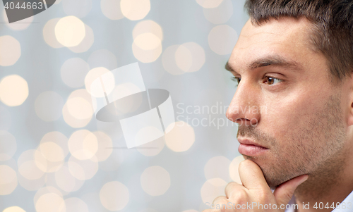 Image of close up of male face over lights background