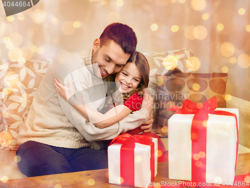 Image of smiling father and daughter hugging