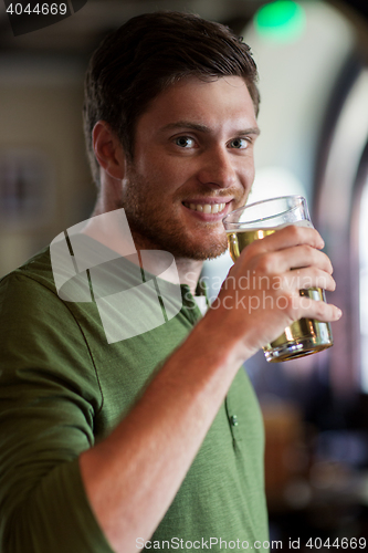 Image of happy man drinking beer at bar or pub