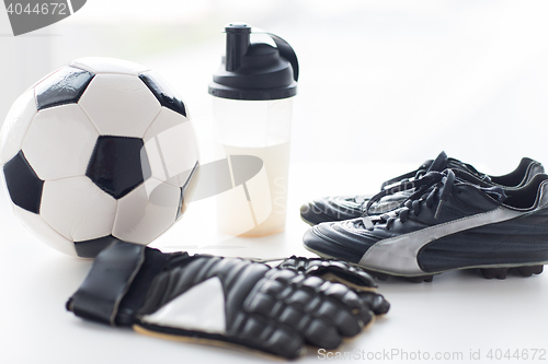 Image of close up of football boots, gloves and bottle