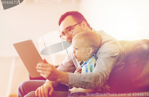 Image of father and son with tablet pc playing at home