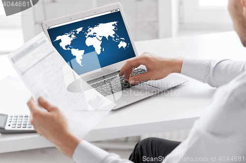 Image of businessman with laptop computer working at office