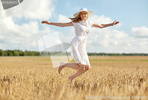 Image of happy young woman jumping on cereal field