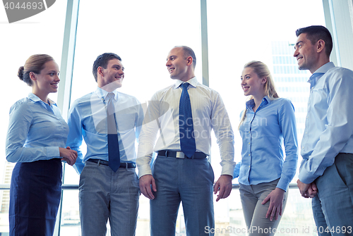 Image of smiling businesspeople meeting in office