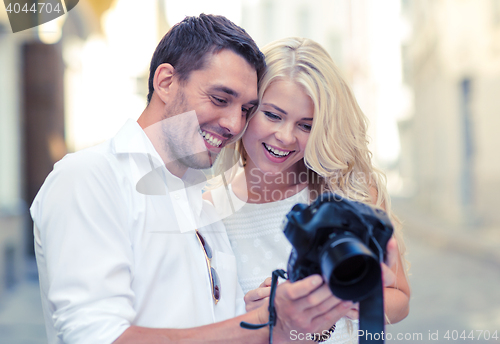 Image of smiling couple with photo camera