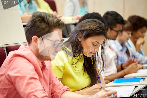 Image of group of international students writing at lecture