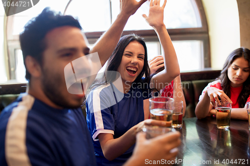 Image of football fans with beer celebrating victory at bar