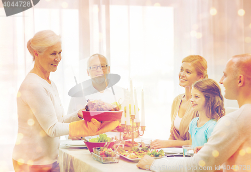 Image of smiling family having holiday dinner at home