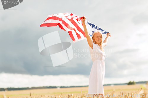 Image of happy woman with american flag on cereal field