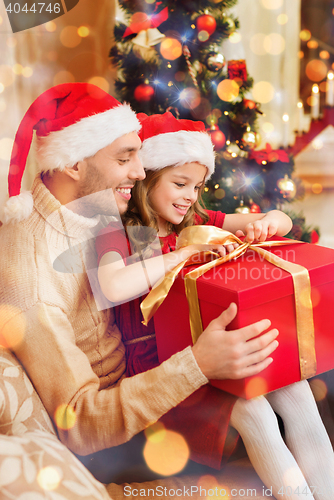 Image of smiling father and daughter opening gift box