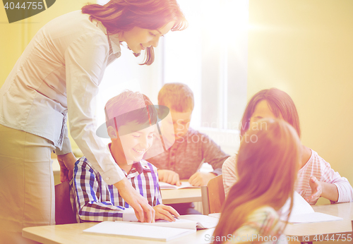 Image of group of school kids writing test in classroom