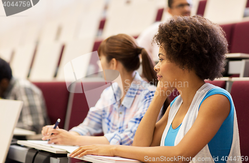 Image of group of students talking in lecture hall
