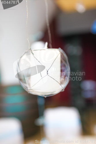 Image of Candle, hanging in a glass bowl