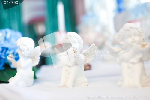 Image of Three statues of angels on the table