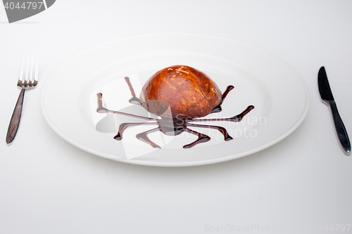 Image of dessert with chocolate spider web