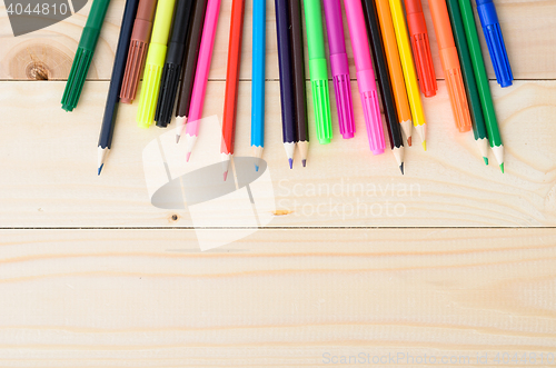 Image of Colored pencils on a wooden board
