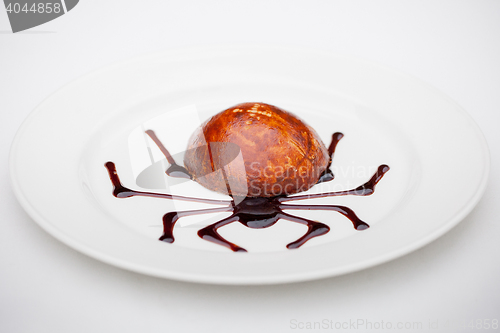 Image of dessert with chocolate spider web
