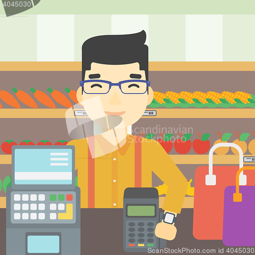 Image of Man paying wireless with smart watch.
