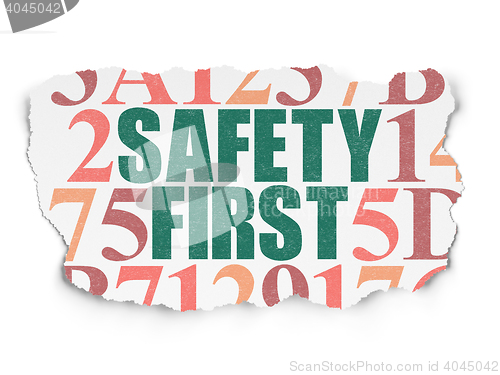 Image of Safety concept: Safety First on Torn Paper background