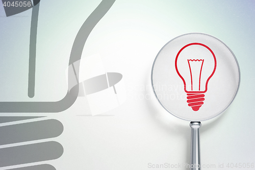 Image of Business concept:  Light Bulb with optical glass on digital background
