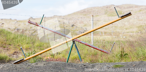 Image of Old wooden and steel seesaw