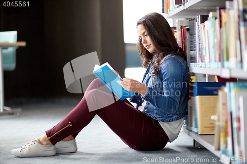 Image of high school student girl reading book at library