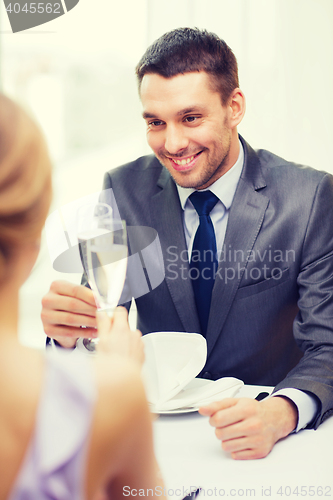 Image of couple with glasses of champagne at restaurant