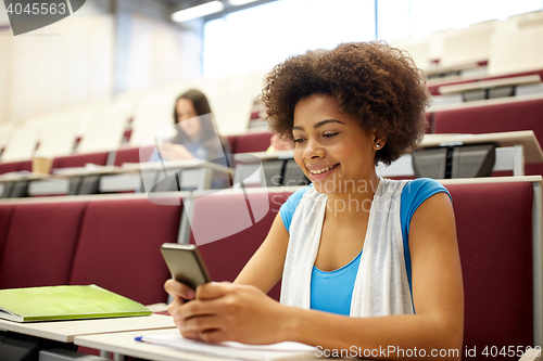 Image of african student girl with smartphone at lecture