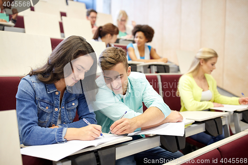 Image of group of students with notebooks at lecture hall