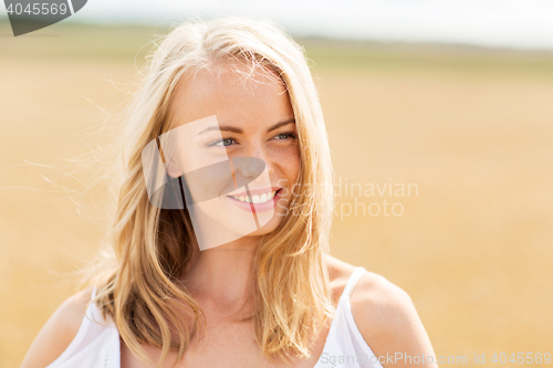 Image of smiling young woman in white on cereal field