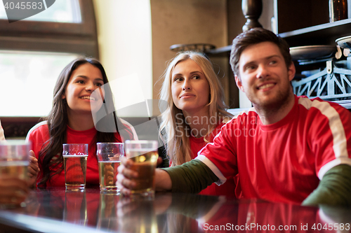 Image of fans or friends watching football at sport bar
