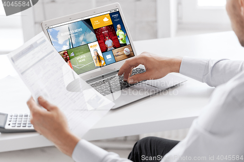 Image of businessman with laptop computer working at office