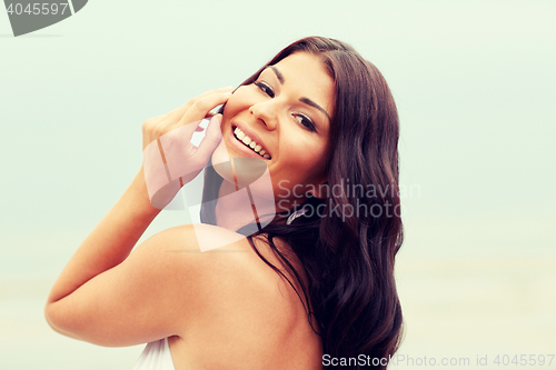 Image of happy young woman on beach