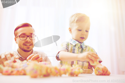 Image of father and son playing with ball clay at home