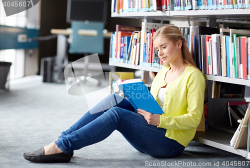 Image of high school student girl reading book at library