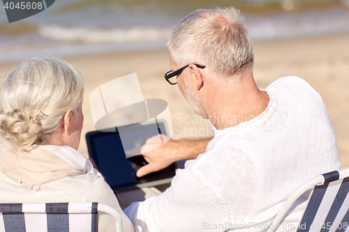 Image of close up of senior couple with tablet pc on beach
