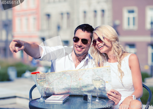 Image of couple with map in cafe