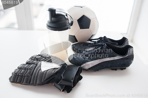Image of close up of football, boots, gloves and bottle