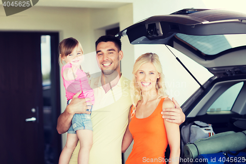 Image of happy family with hatchback car at home parking