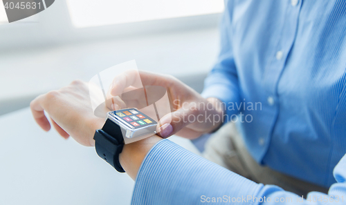 Image of close up of hands with menu icons on smart watch