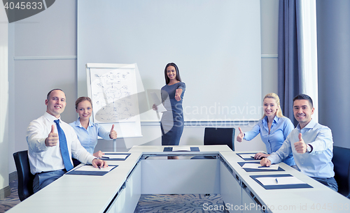 Image of group of smiling businesspeople showing thumbs up