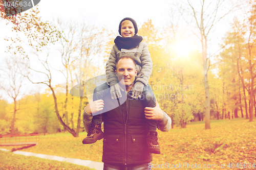 Image of happy family having fun in autumn park