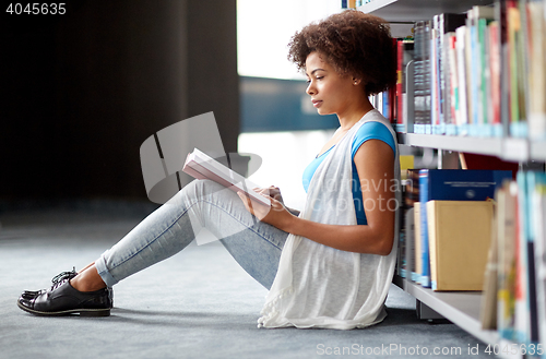 Image of african student girl reading book at library