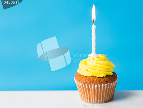 Image of birthday cupcake with one burning candle