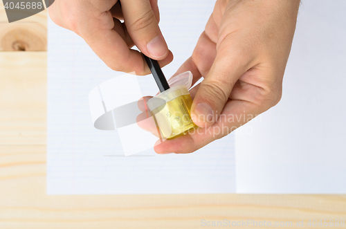 Image of Top view of man\'s hands sharpening pencil