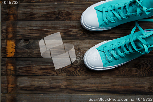 Image of blue shoes on empty wooden parquet