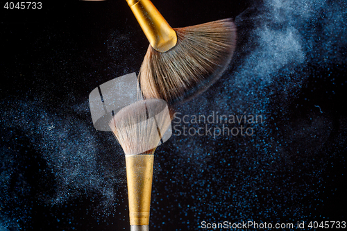 Image of Thick professional brush and cloud loose powder particles