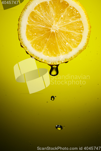 Image of Drop of lemon juice falling down.