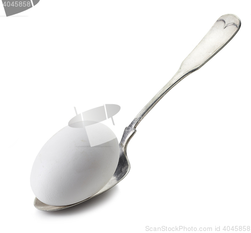 Image of white egg in a spoon